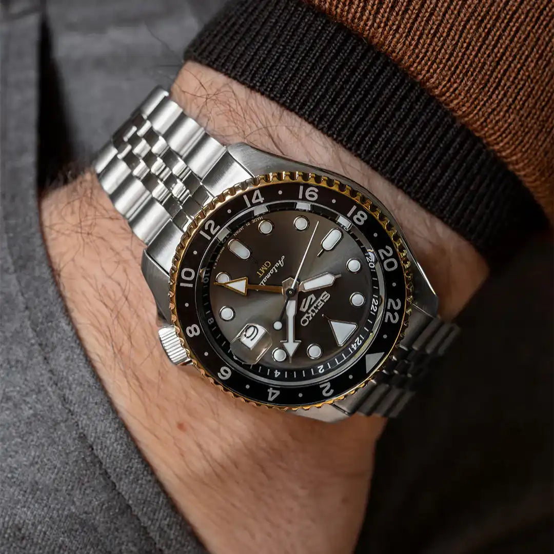 Seiko 5 100M GMT Style U.S. Special Black on Gold Plated Bezel Charcoal Dial Stainless Steel Watch SSK021 J1