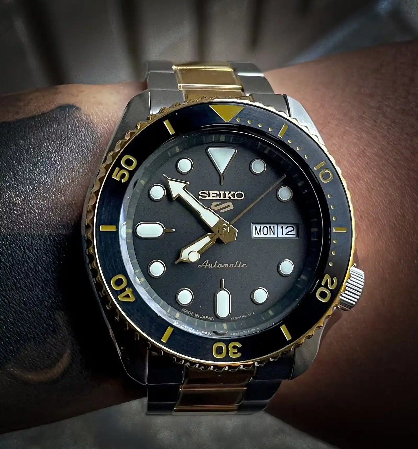 Seiko 5 Sports 100M U.S. Special Black Bezel Charcoal Dial 2-Tone Gold Plated Stainless Steel Watch SRPK22 J1