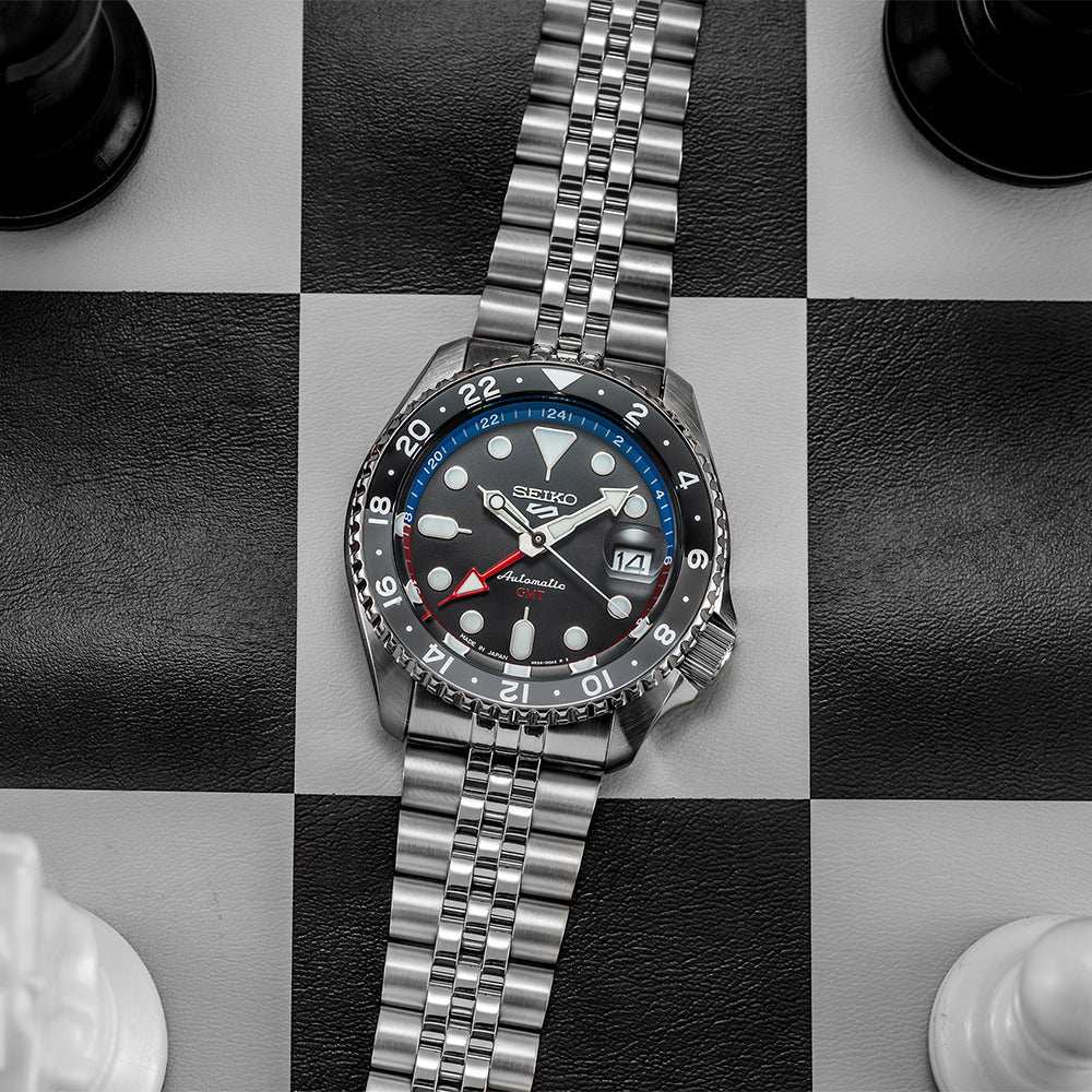 Seiko 5 100M GMT Style U.S. Special Black and Gray Bezel Red and Blue Inner Ring Charcoal Dial Stainless Steel Watch SSK019 J1